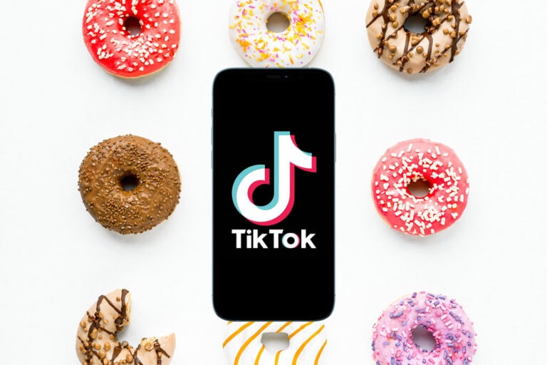 TikTok app on mobile phone above donuts