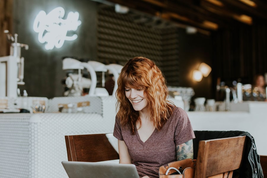 Woman using computer in cafe