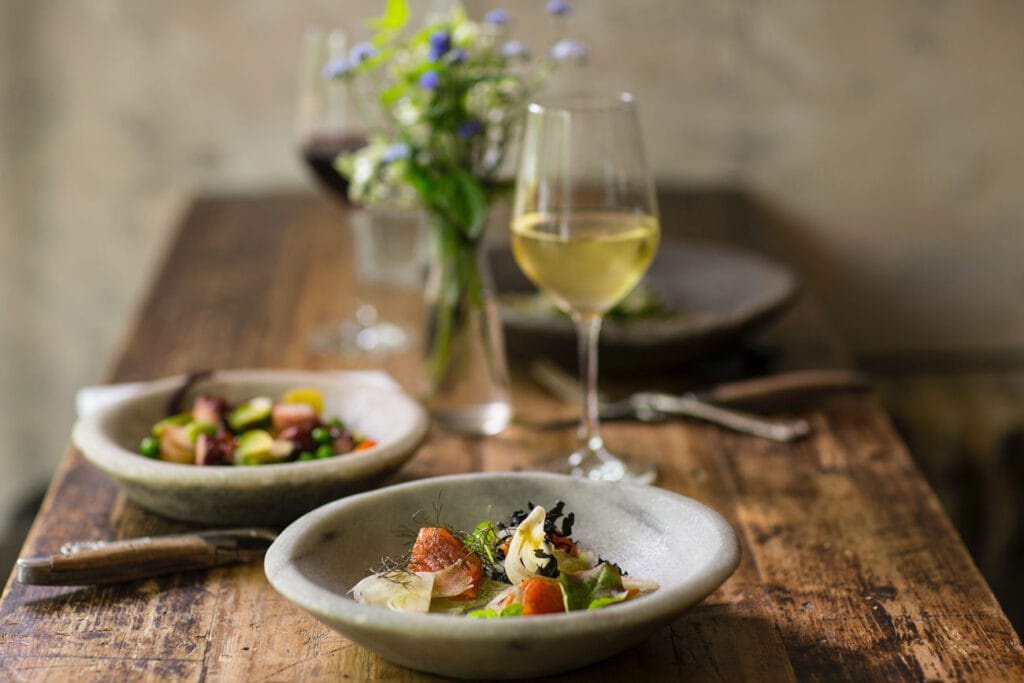 A rustic table with food in a restaurant